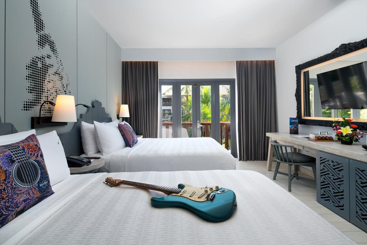 guitar laying on a bed